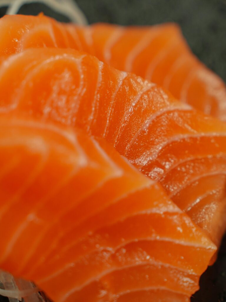 Appetizing close-up of fresh raw salmon sashimi, perfect for food photography lovers.